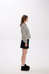 Person wearing a striped shirt and black skirt on a white background