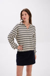Woman wearing a black and white striped shirt with a navy skirt on a white background