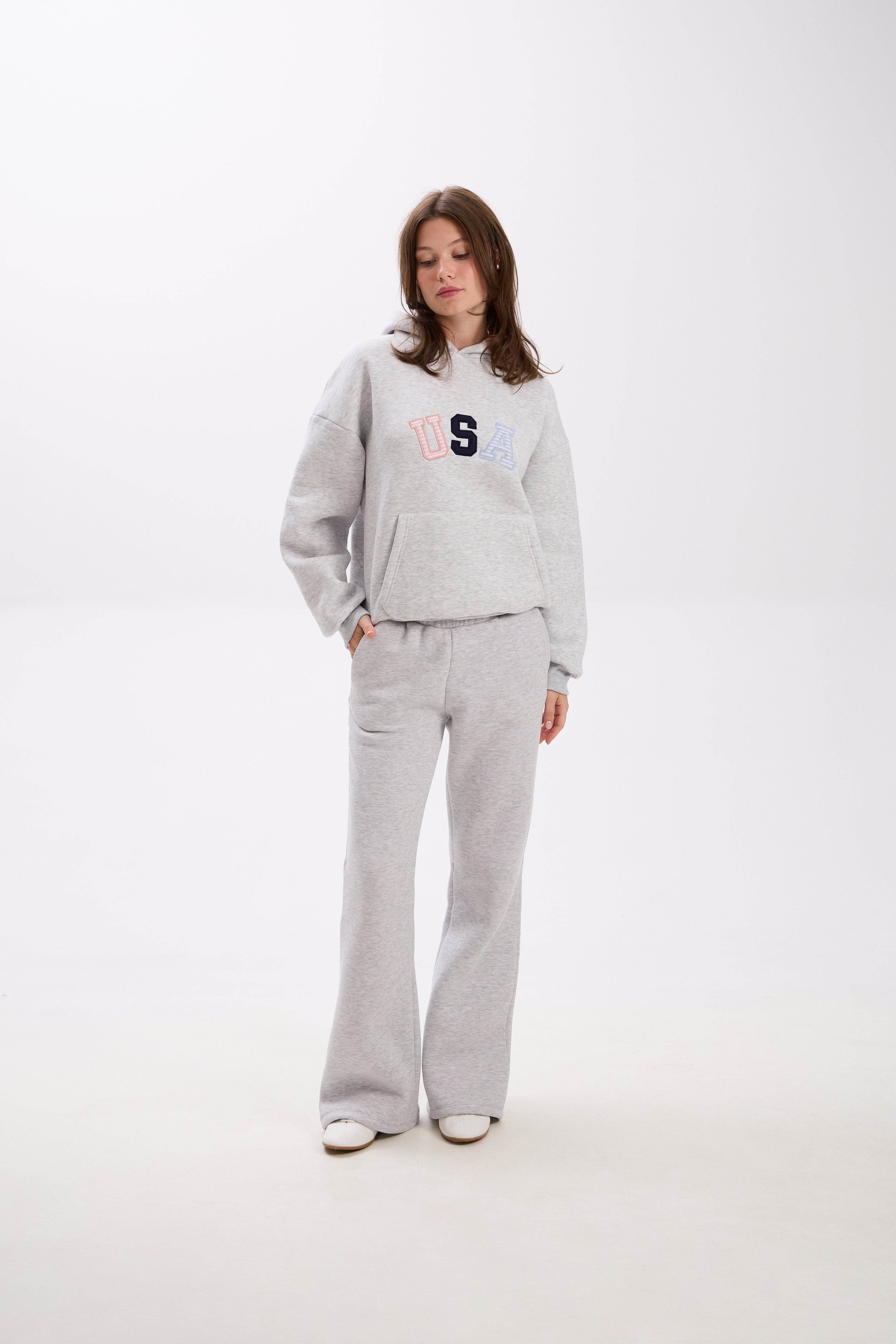 Grey USA hoodie and sweatpants set with elastic waist, side pockets, and multicolor embroidery.