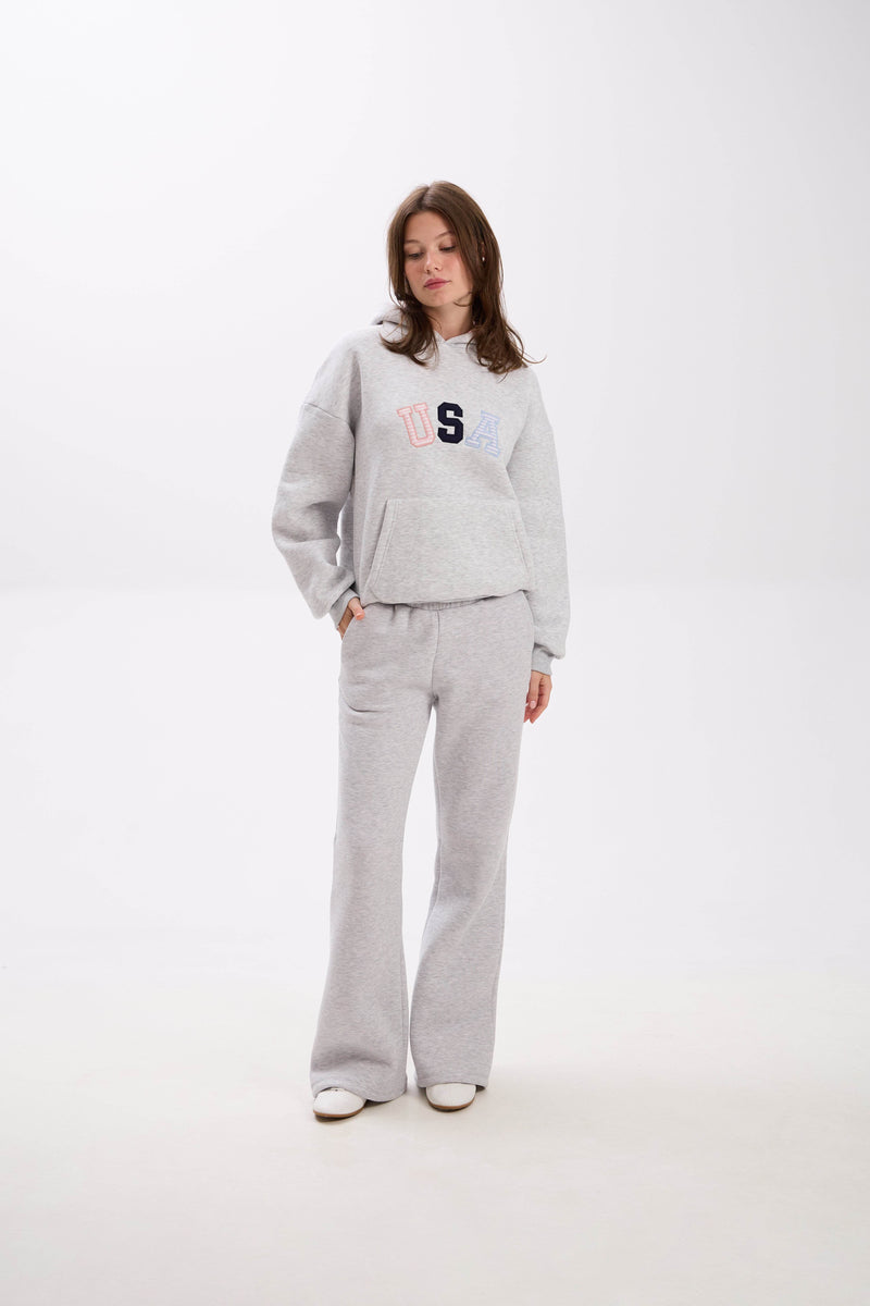 Grey USA hoodie and sweatpants set with elastic waist, side pockets, and multicolor embroidery.