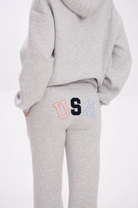 Grey hoodie and sweatpants with elastic waistband, side pockets, and multicolor USA lettering on the back.