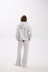 Grey hoodie and sweatpants with elastic waistband, side pockets, and multicolor USA lettering on the back.