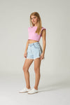 Woman wearing a pink crop top and light blue denim shorts on a white background.