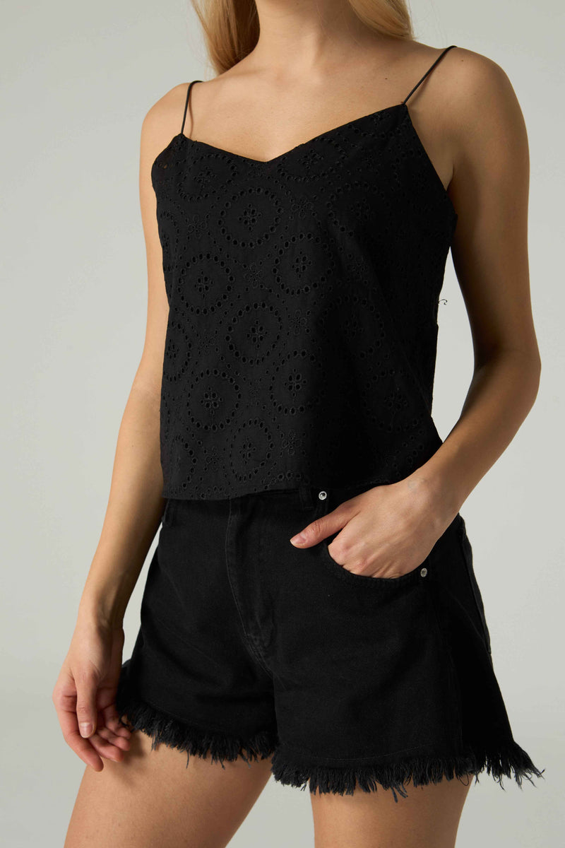 Black lace top and shorts set on a neutral background.