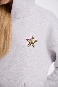 Gray sweatshirt with a leopard print star design on a plain background