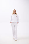 Person wearing a white outfit with a star design on a white background