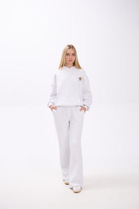 Person wearing a white outfit with a star design on a white background