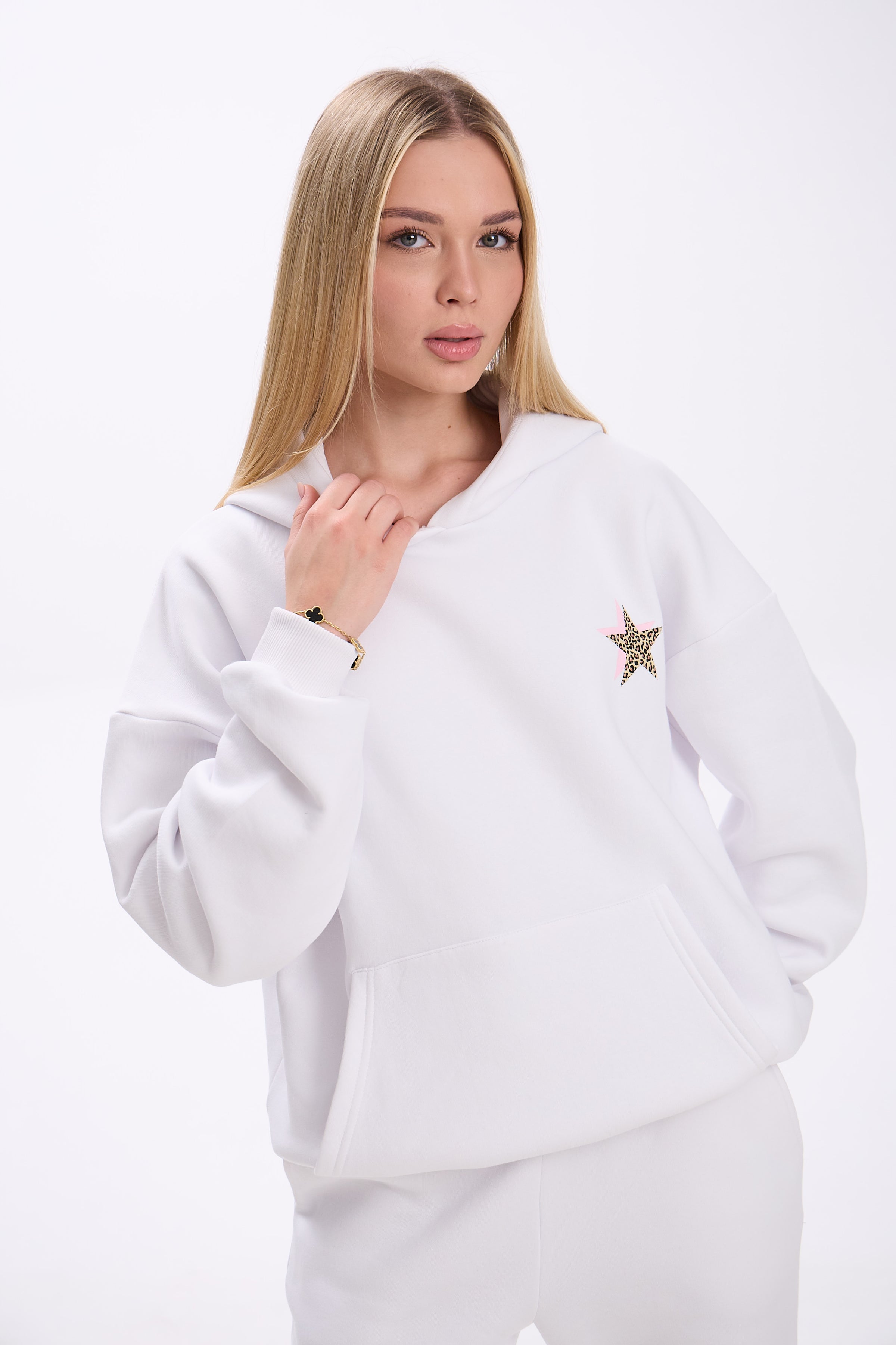 Woman wearing a white sweatshirt with a star design on a white background