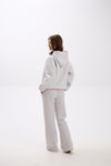 Grey sweatpants with elastic waistband, side pockets, and pink “Stay Close” embroidery on the back.