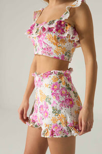 Floral two-piece outfit on a neutral background.