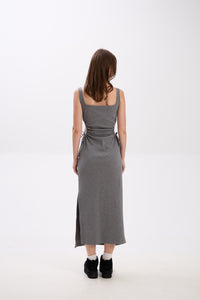 Woman wearing a gray dress on a white background.