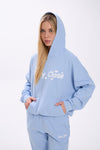 Person wearing a light blue hoodie with white 'Stay Close' text on a white background.