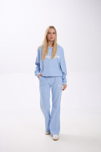 Person wearing a light blue tracksuit with 'Stay Close' text on a white background.