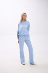 Woman wearing a light blue hoodie and sweatpants with 'Stay Close' text on a white background.