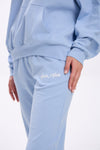 Light blue sweatpants with 'Stay Close' text on a white background.
