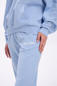 Light blue sweatpants with 'Stay Close' text on a white background.