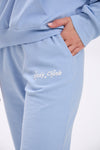 Light blue sweatpants with 'Stay Close' text on a white background.