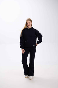 Person wearing a black outfit on a white background.