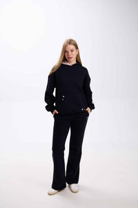 Person wearing a black outfit on a white background.