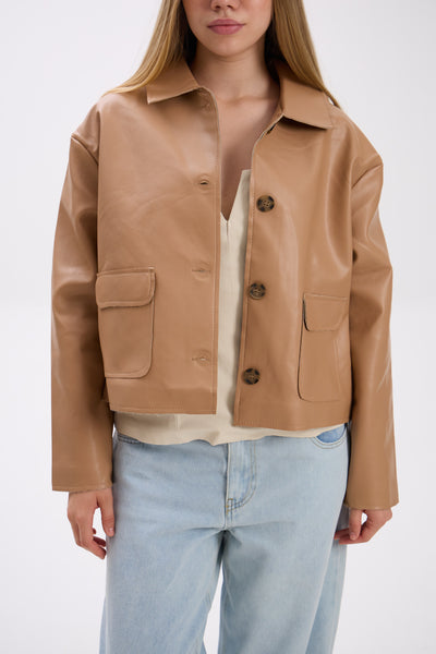 Person wearing a tan leather jacket with a white background.