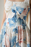 Floral dress with blue and pink flowers on a neutral background.