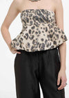 Leopard print peplum top worn by a person on a white background.