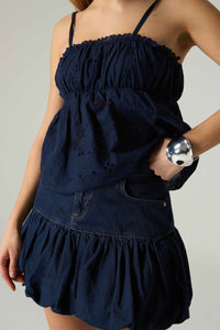 Navy blue dress with ruffled top and layered skirt on a plain background.