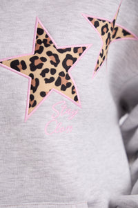 Gray sweatshirt with leopard print star and pink text on a plain background