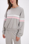 Gray sweatshirt with pink and white stripes worn by a person on a white background.