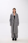 Person wearing a gray coat on a white background