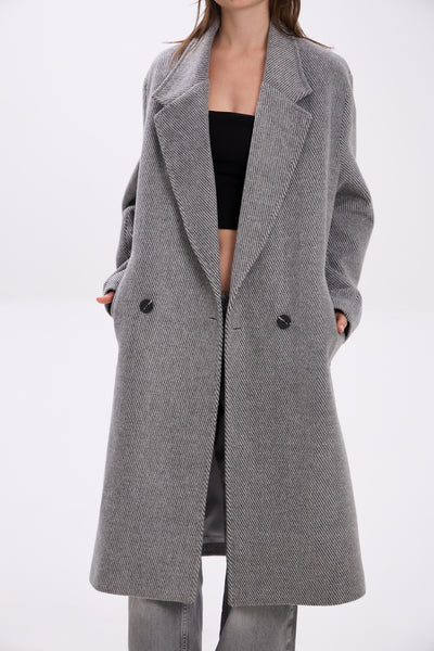 Gray coat worn by a person on a white background