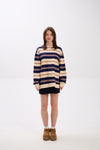 Person wearing a striped sweater on a white background
