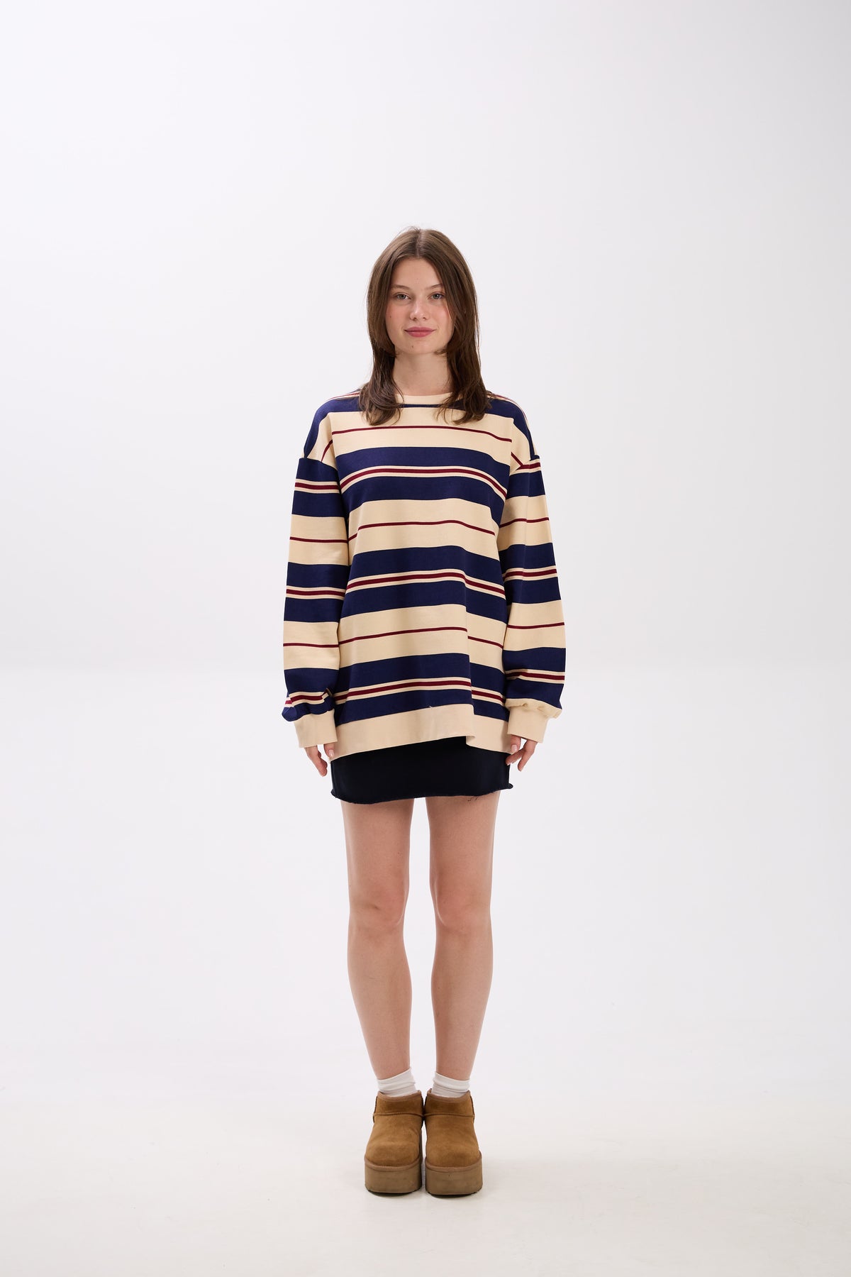 Person wearing a striped sweater on a white background