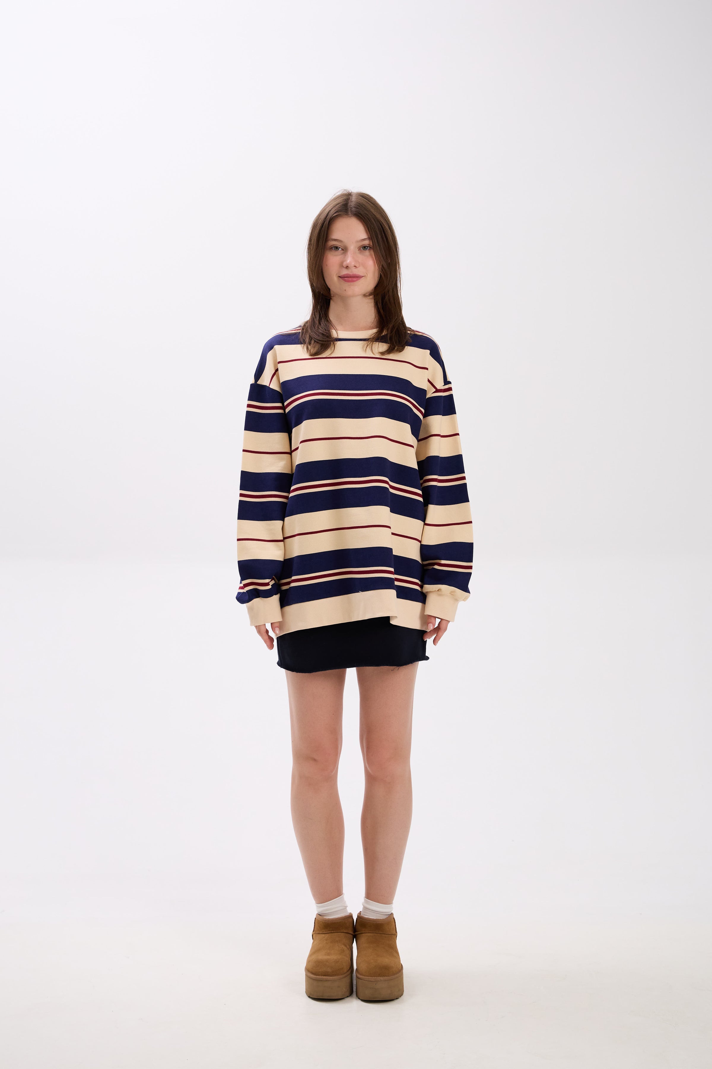 Person wearing a striped sweater on a white background