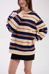 Person wearing a striped sweater and black skirt on a white background