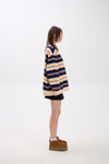 Person wearing a striped sweater and boots on a white background