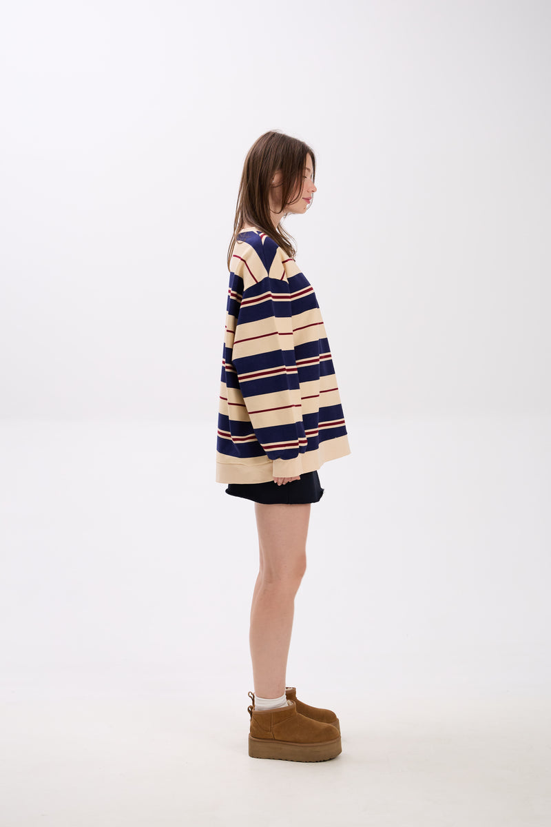 Person wearing a striped sweater and boots on a white background