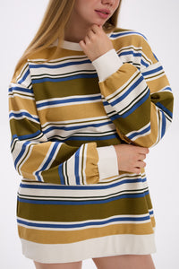 Person wearing a striped dress with long sleeves on a white background