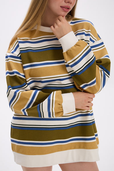 Person wearing a striped dress with long sleeves on a white background