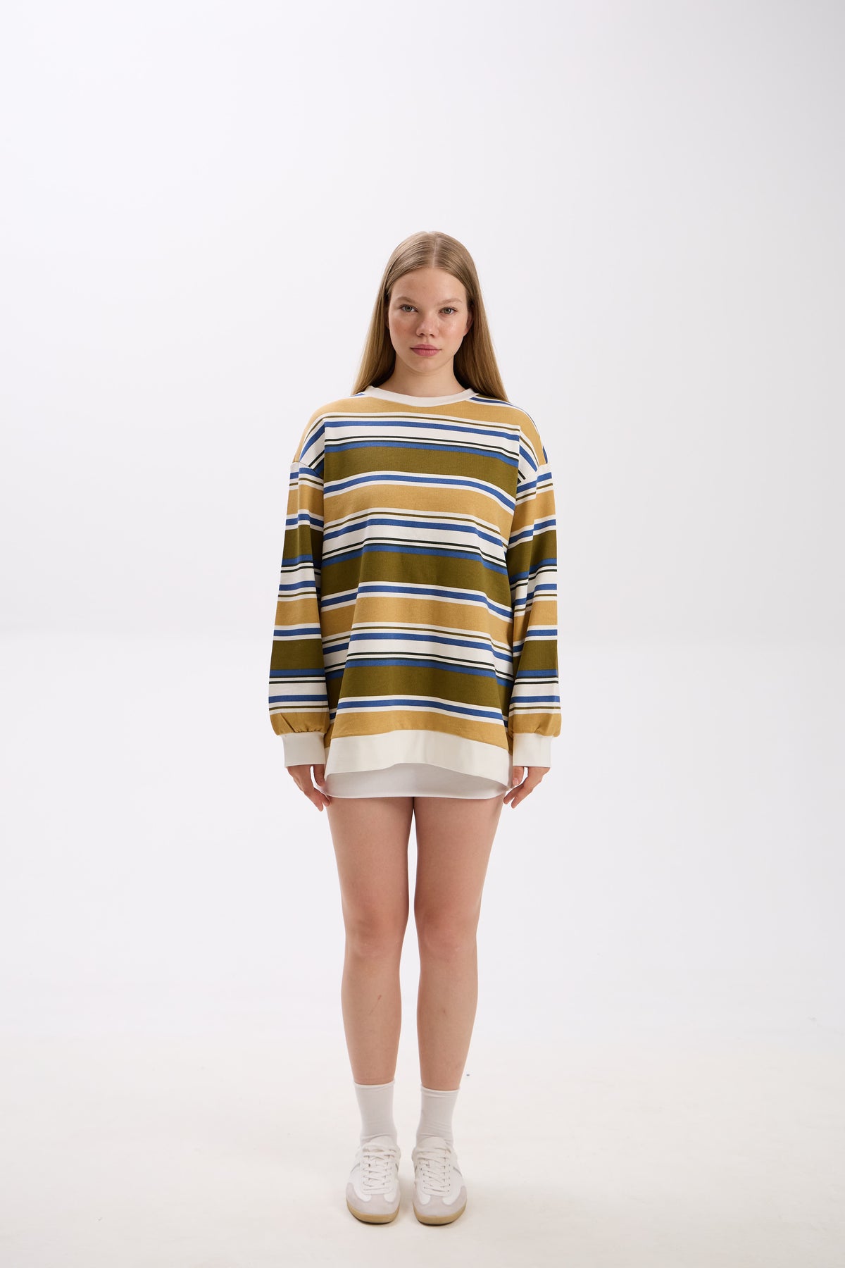 Person wearing a striped sweater on a white background