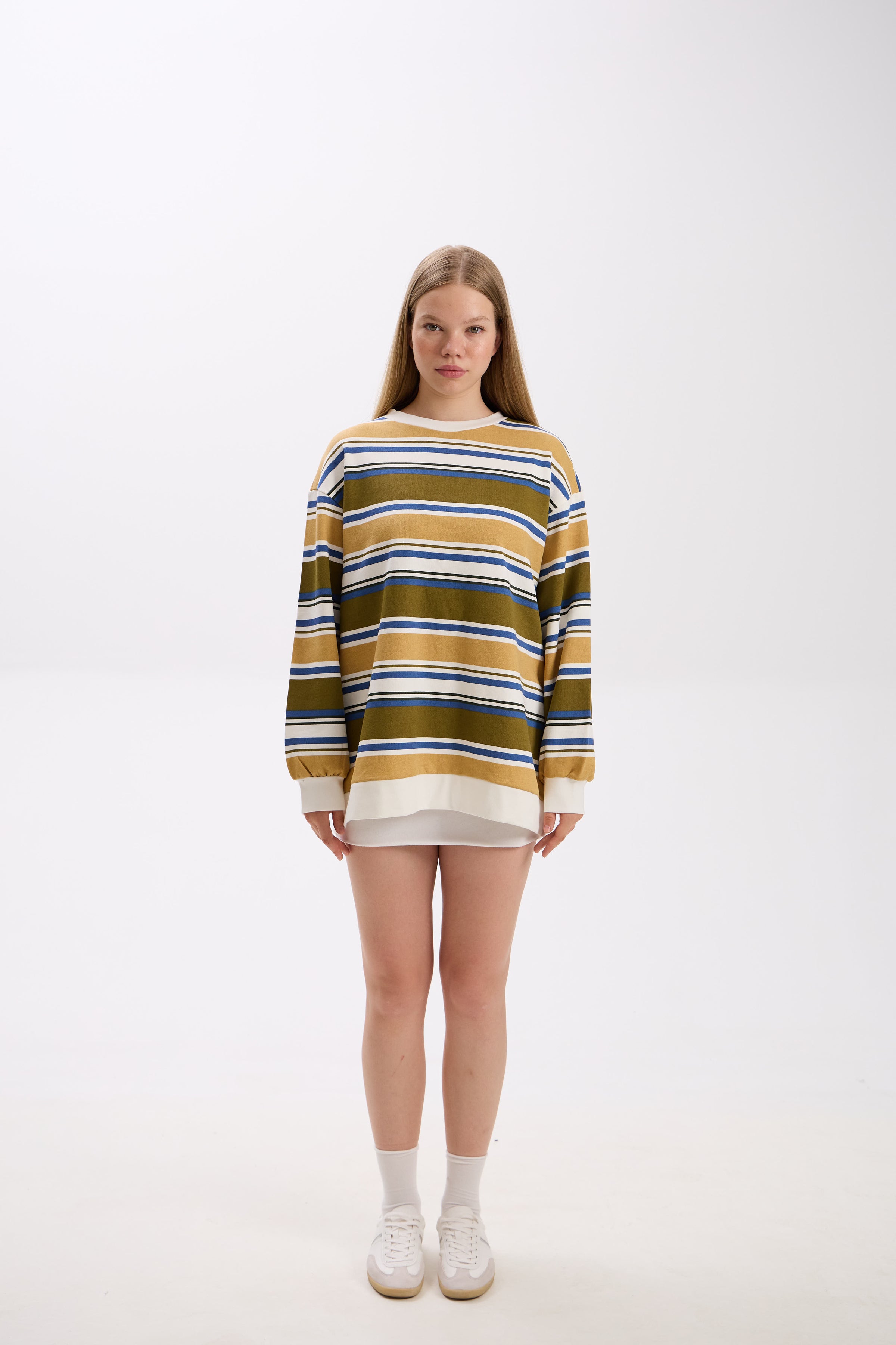 Person wearing a striped sweater on a white background