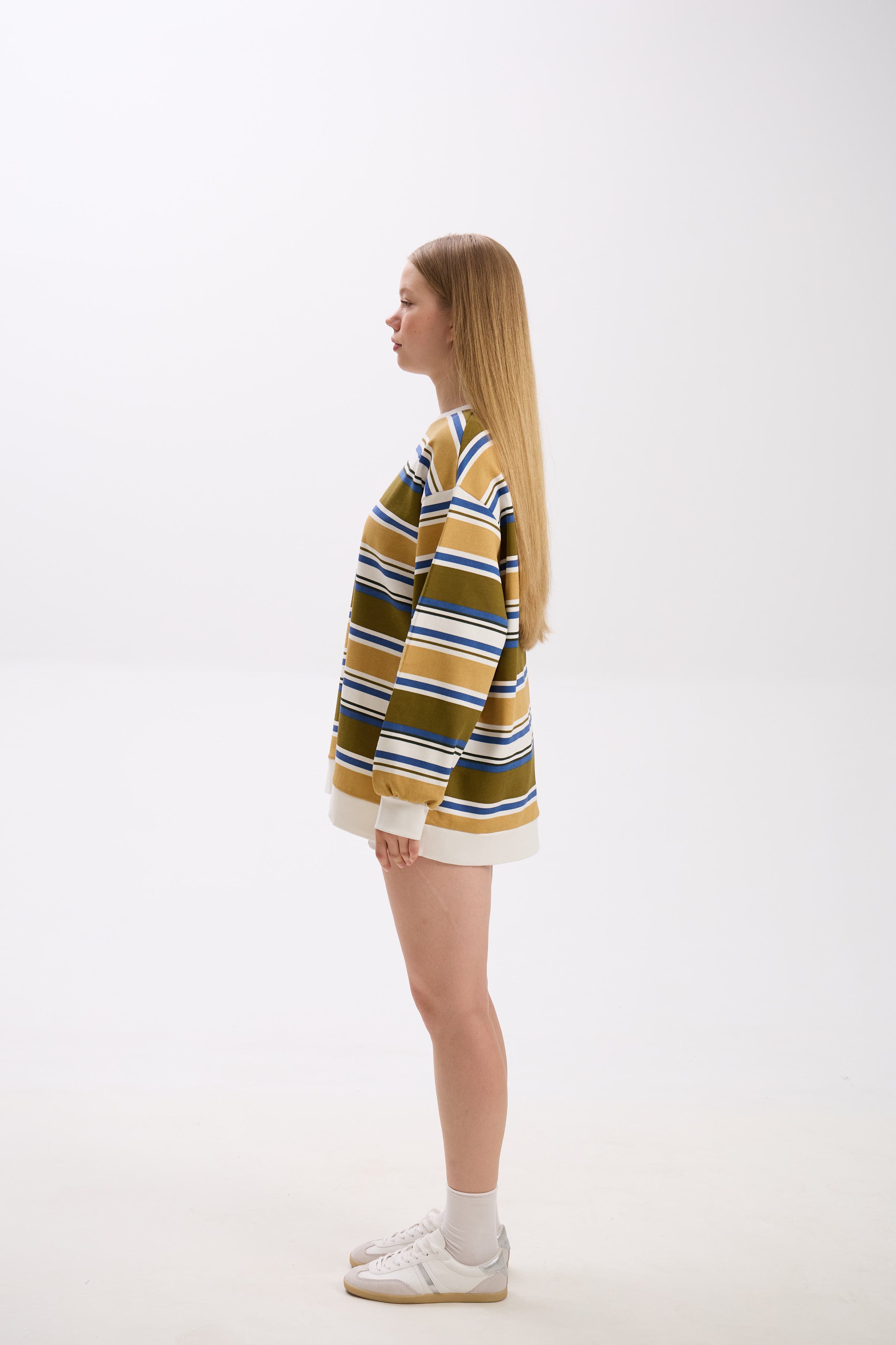 Person wearing a striped sweater on a white background