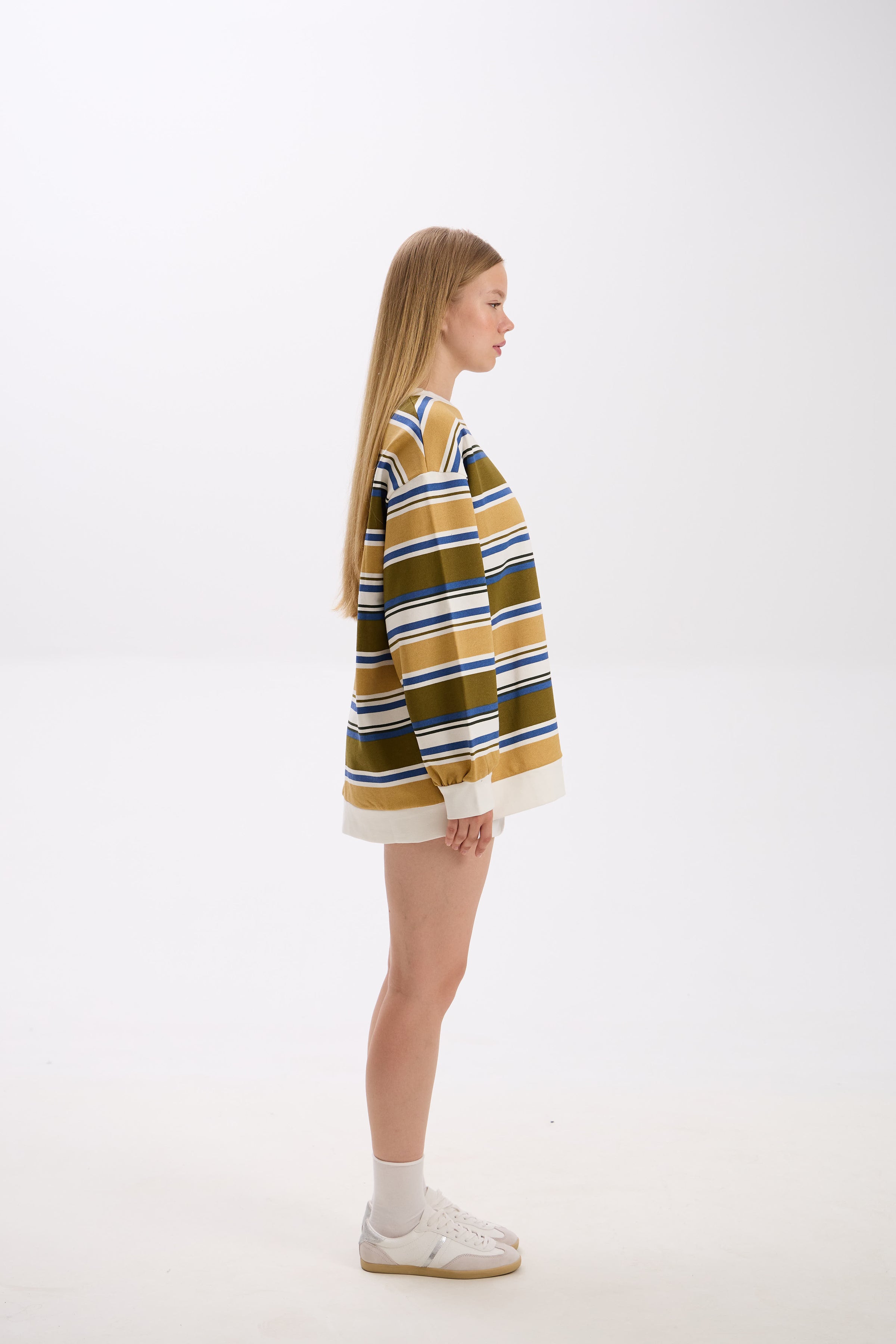 Person wearing a striped sweater on a white background