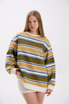 Woman wearing a striped sweater with a white background