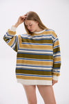 Woman wearing a striped sweater with a white background