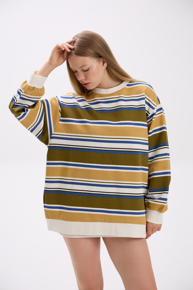 Woman wearing a striped sweater with a white background