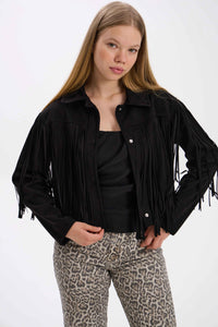 Person wearing a black fringed jacket and leopard print pants on a white background.