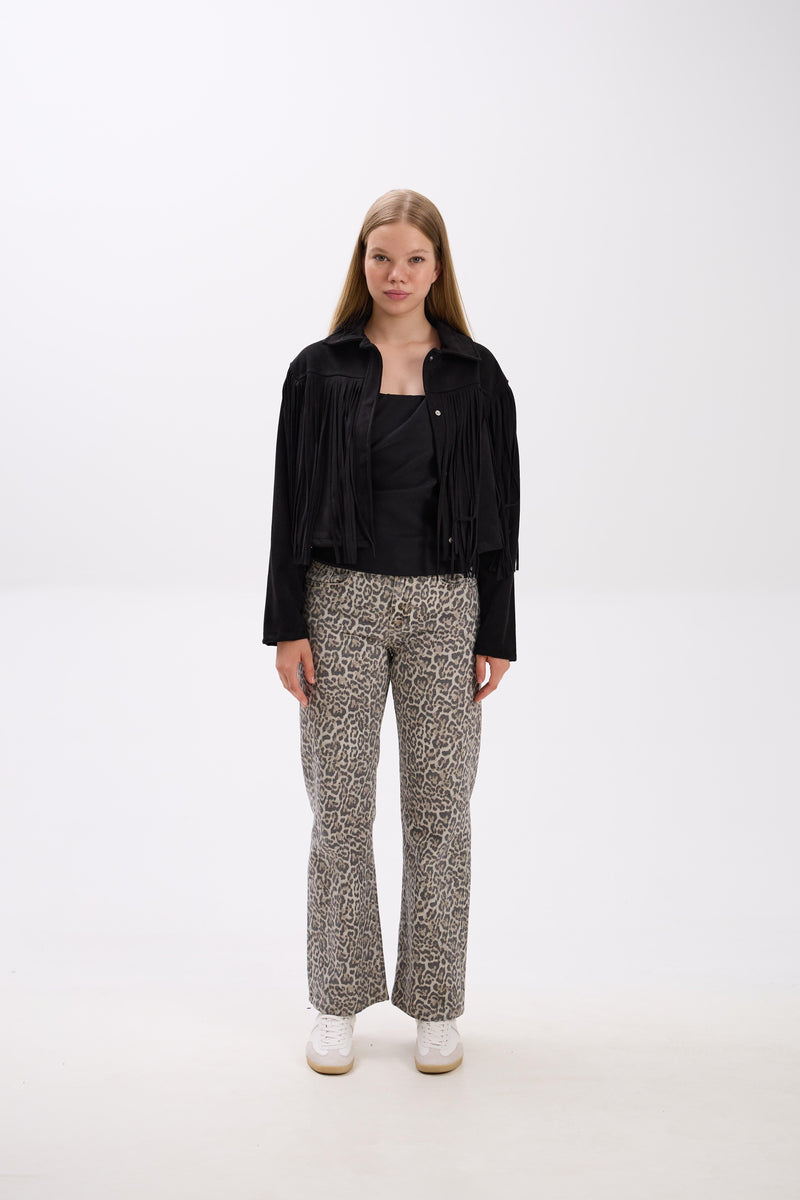 Person wearing a black jacket and patterned pants on a white background.