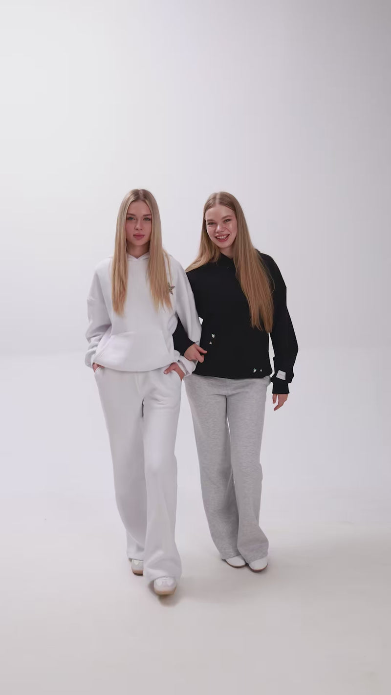 2 girls with hoodies and sweatpants introducing their clothes.