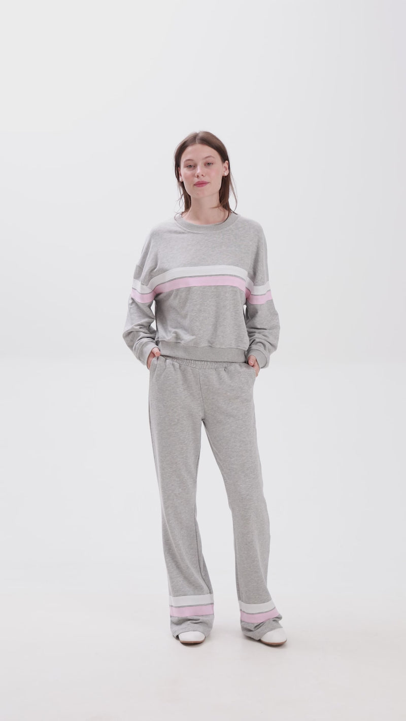Grey sweat set with pink stripe details, elastic waistband and side pockets for a comfy casual look.